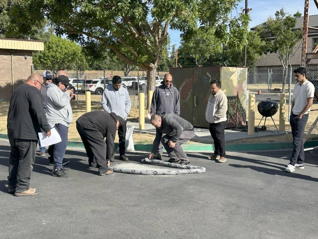 People inspecting an object on the ground.
