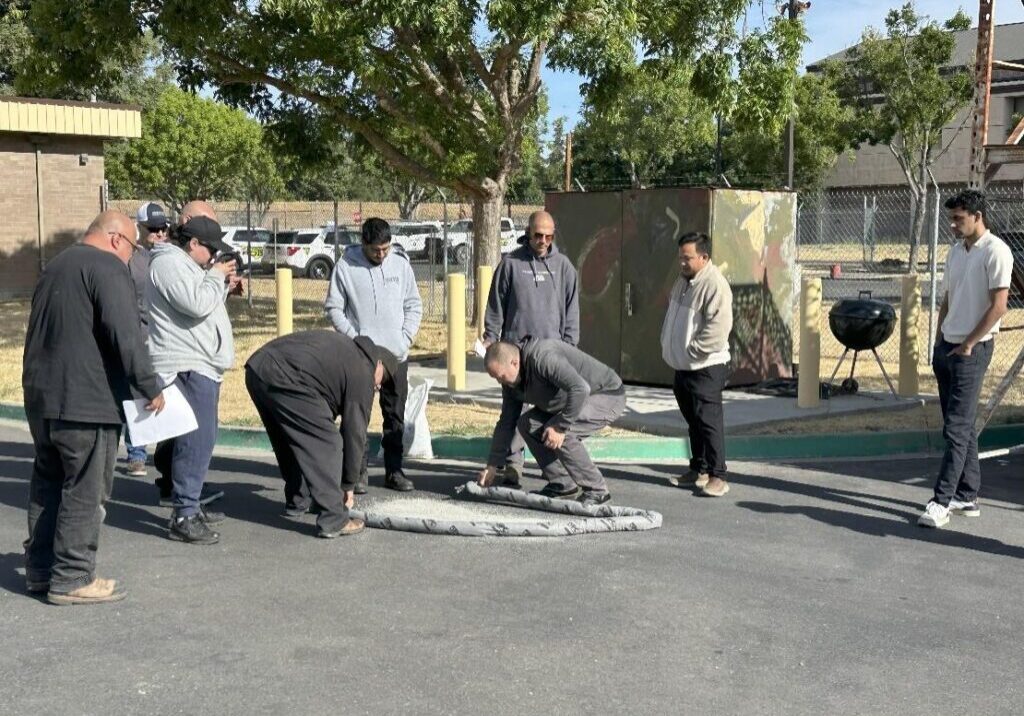 People inspecting an object on the ground.